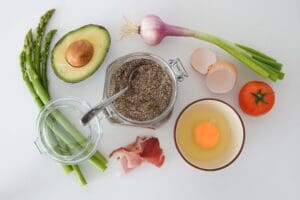 A selection of healthy foods laid out on a table. The colours are bright and the food looks delicious.